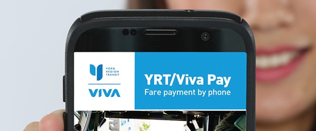Woman holding mobile phone showing YRT Pay app